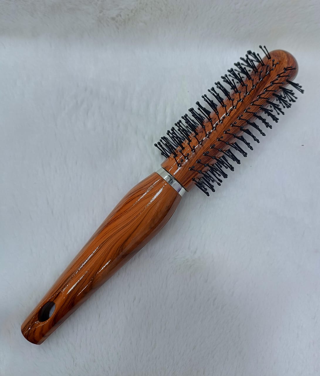 Woman Hand with Round Hair Brush on White Background – Perfect Styling Companion