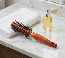 Woman Hand with Round Hair Brush on White Background – Perfect Styling Companion